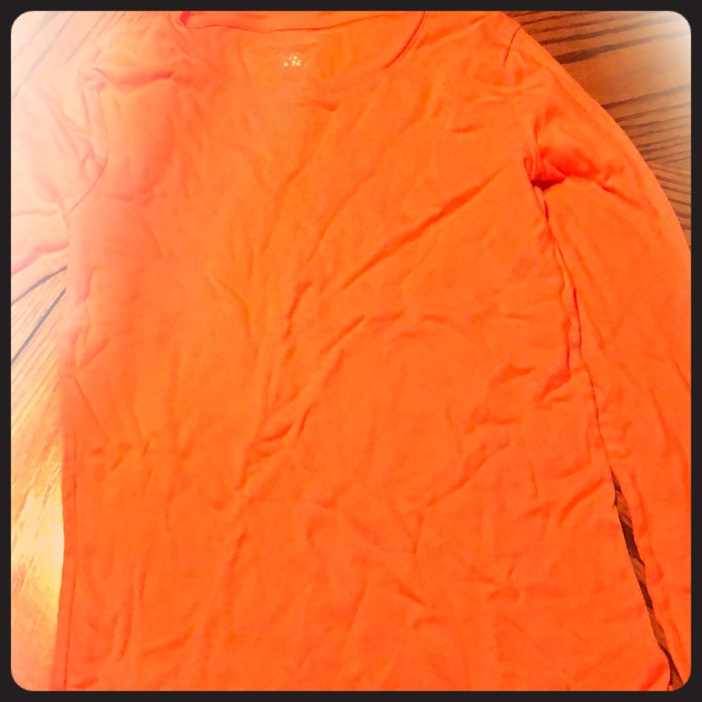 A bright orange shirt that is long sleeve